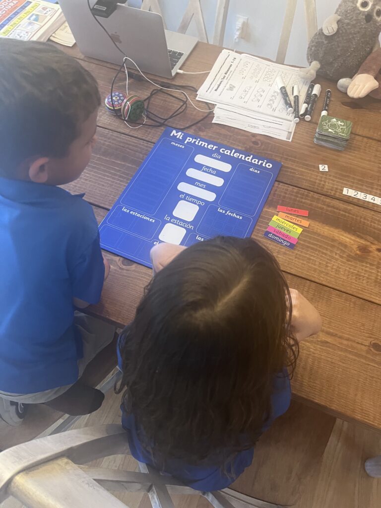 Young learners using visual tools, showing English for beginners (starter strategies) in a real home study setting.