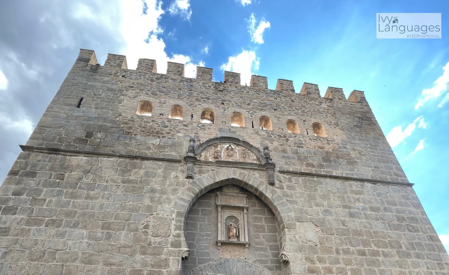 Essential vocabulary for English beginners in a travel learning scene at an ancient city entrance