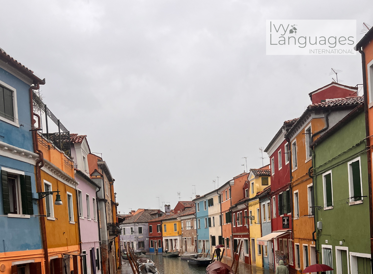 How to practice English pronunciation alone while exploring a colorful canal street in the rain