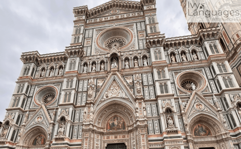 Tourists standing before Florence Cathedral, reflecting moving from intermediate to advanced English.