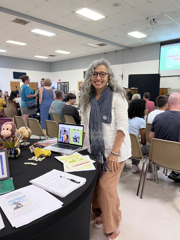 Educator sharing strategies for intermediate English learners during a group learning event.