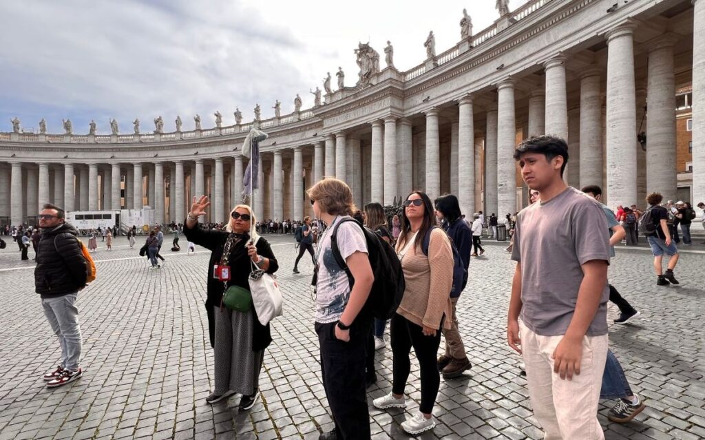 Advanced grammar for intermediate learners applied during guided English immersion tour at St. Peter's Square