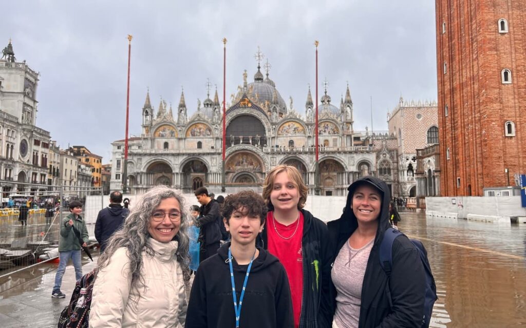 Family practicing daily speaking practice and English conversation practice while sightseeing in Venice's St. Mark's Square 