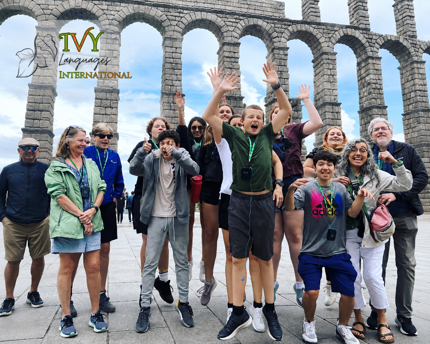 Students practicing complex sentence structures in Spanish during an exciting group trip to the Roman Aqueduct of Segovia.