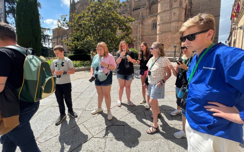 Students improving English speaking skills and English fluency online through real-world language immersion near Salamanca Cathedral