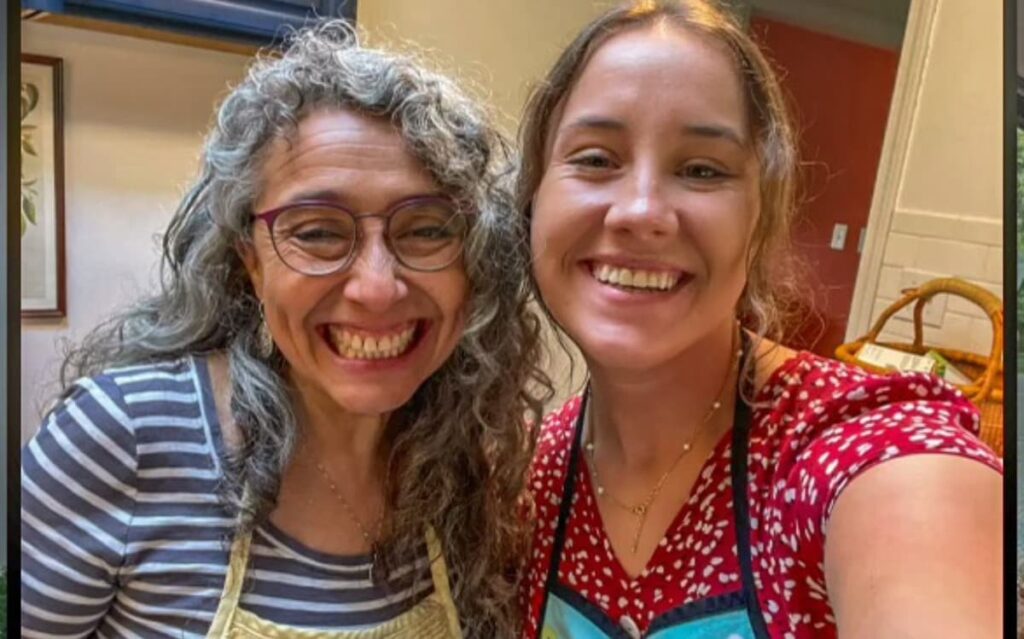 Instructor and student developing professional communication skills and English fluency at an immersive cooking class abroad 