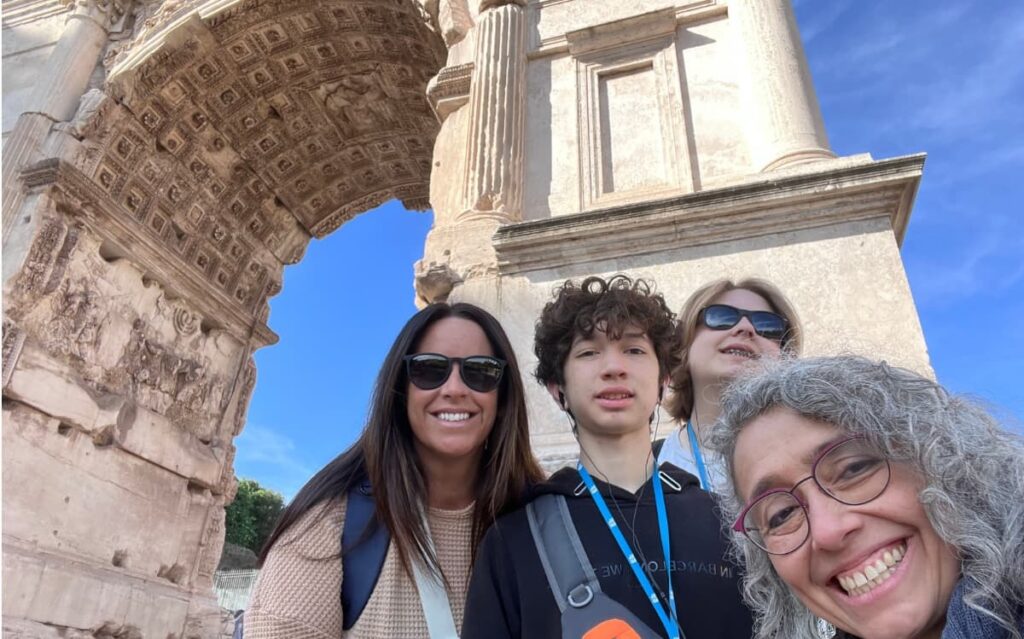Students building English communication skills and spoken English confidence during language immersion tour at Rome's Arch of Titus