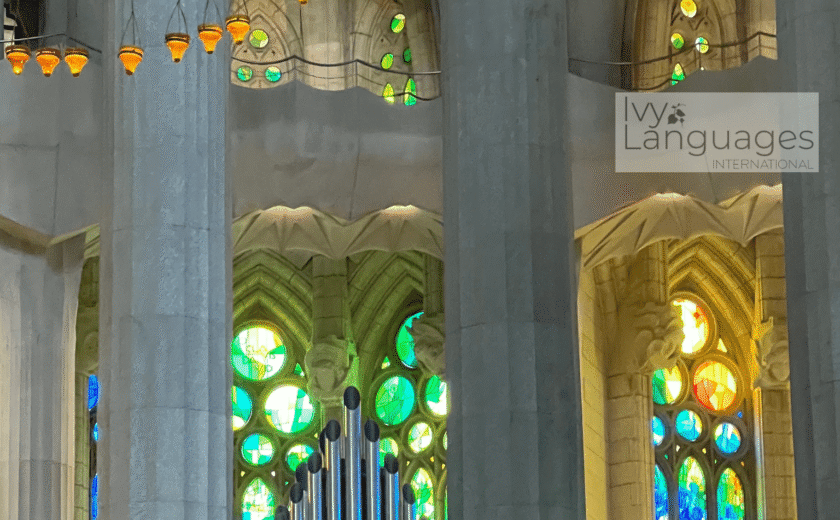 Pipe organ surrounded by vibrant stained glass windows, aid for understanding English cultural references. 